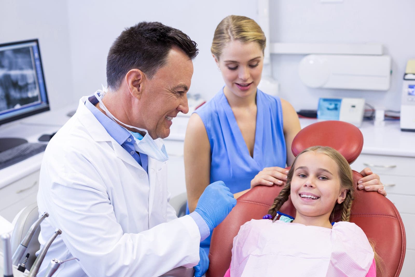 A dentist giving a gentle check-up to a young patient at Chapel House Dentistry